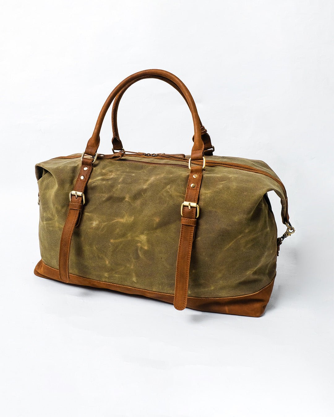 alt="Front view Enlisted honey brown leather duffle, structured body with zip closure and strap loops."