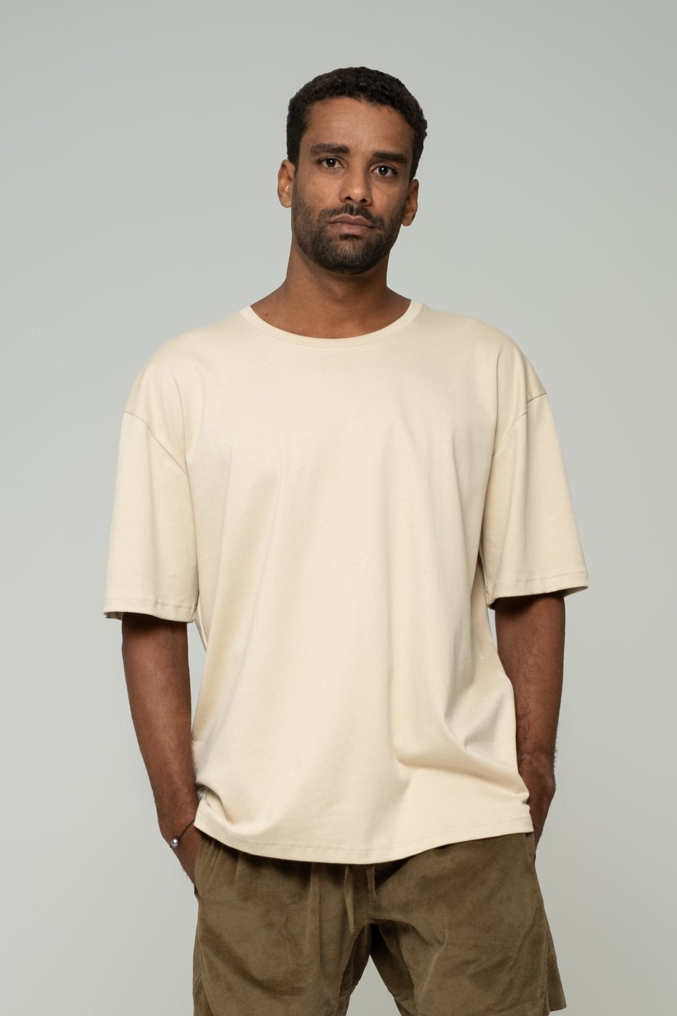 alt="Kavash oversized t‑shirt in off‑white cream, premium heavyweight cotton with antibacterial finish."
