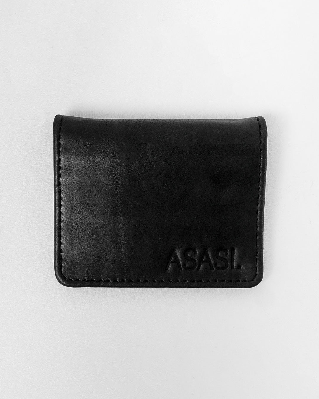 alt="Black leather saddle clip with silver-tone metal clasp, adjustable strap loop."
