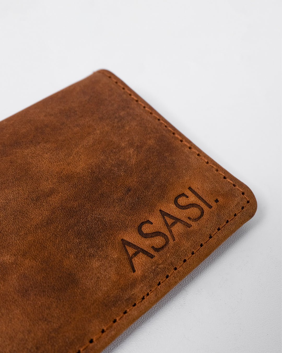 alt="Front view brown leather saddle clip, durable clasp and reinforced leather loop."