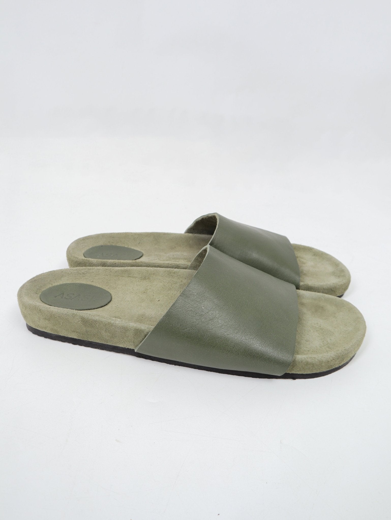 alt="Front view olive Noble slides, open-toe design with textured footbed."