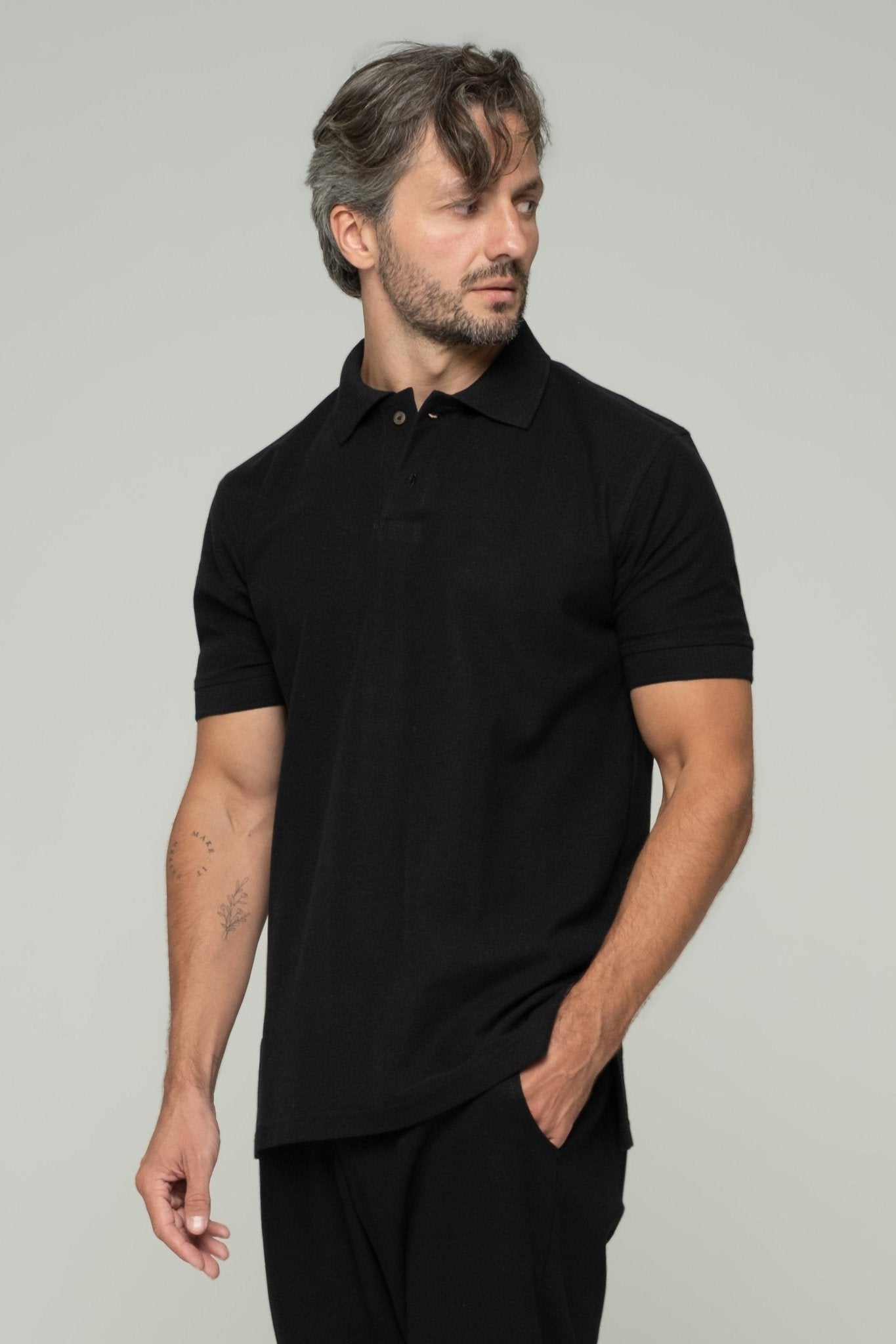 alt="Black ASASI polo shirt front view—classic cotton pique, smart casual staple for men's menswear."