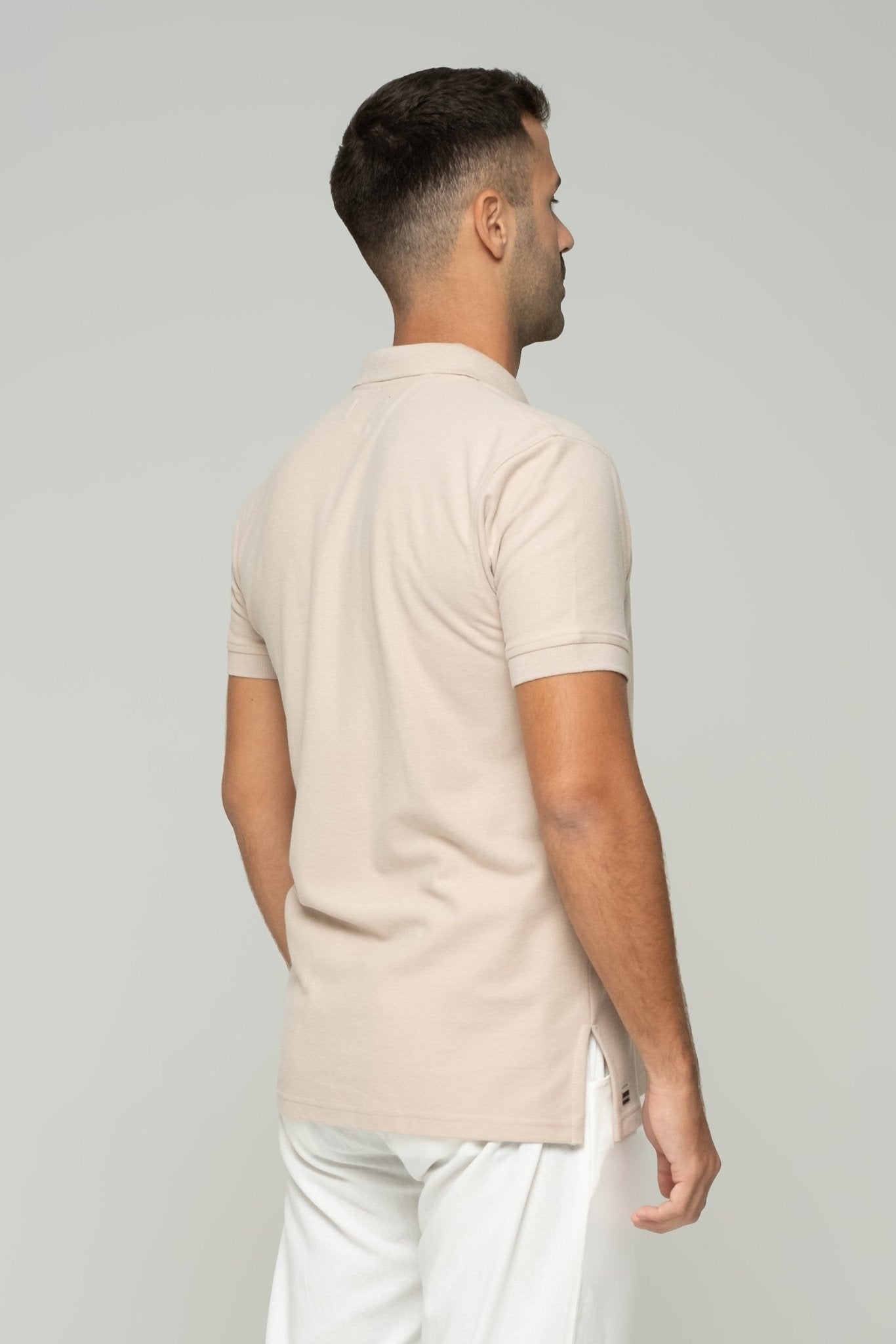 alt="Close‑up of cream ASASI polo shirt collar and placket detail, premium cotton pique texture."