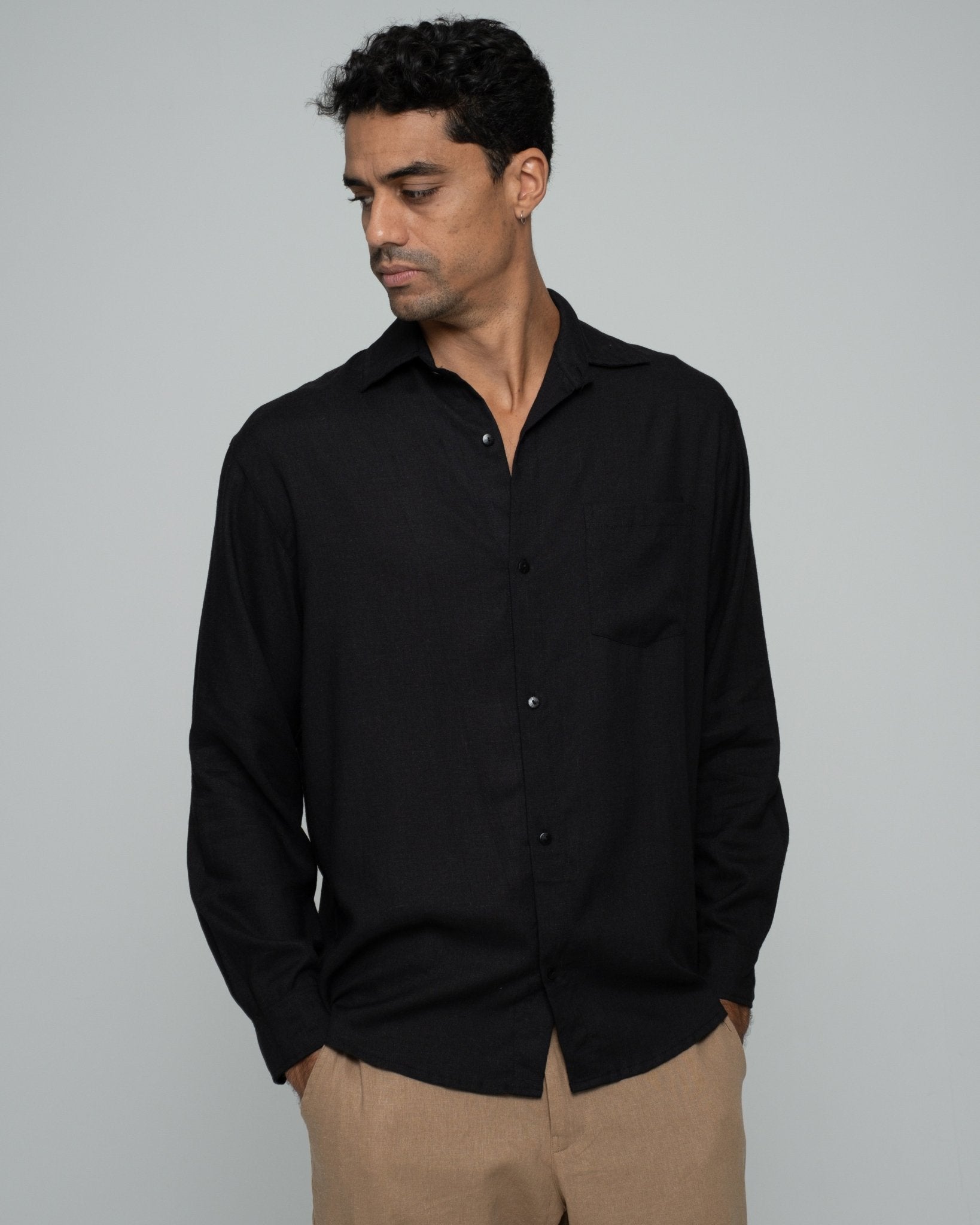 alt="Shadow long-sleeve shirt in black cotton blend, front view with curved hem."