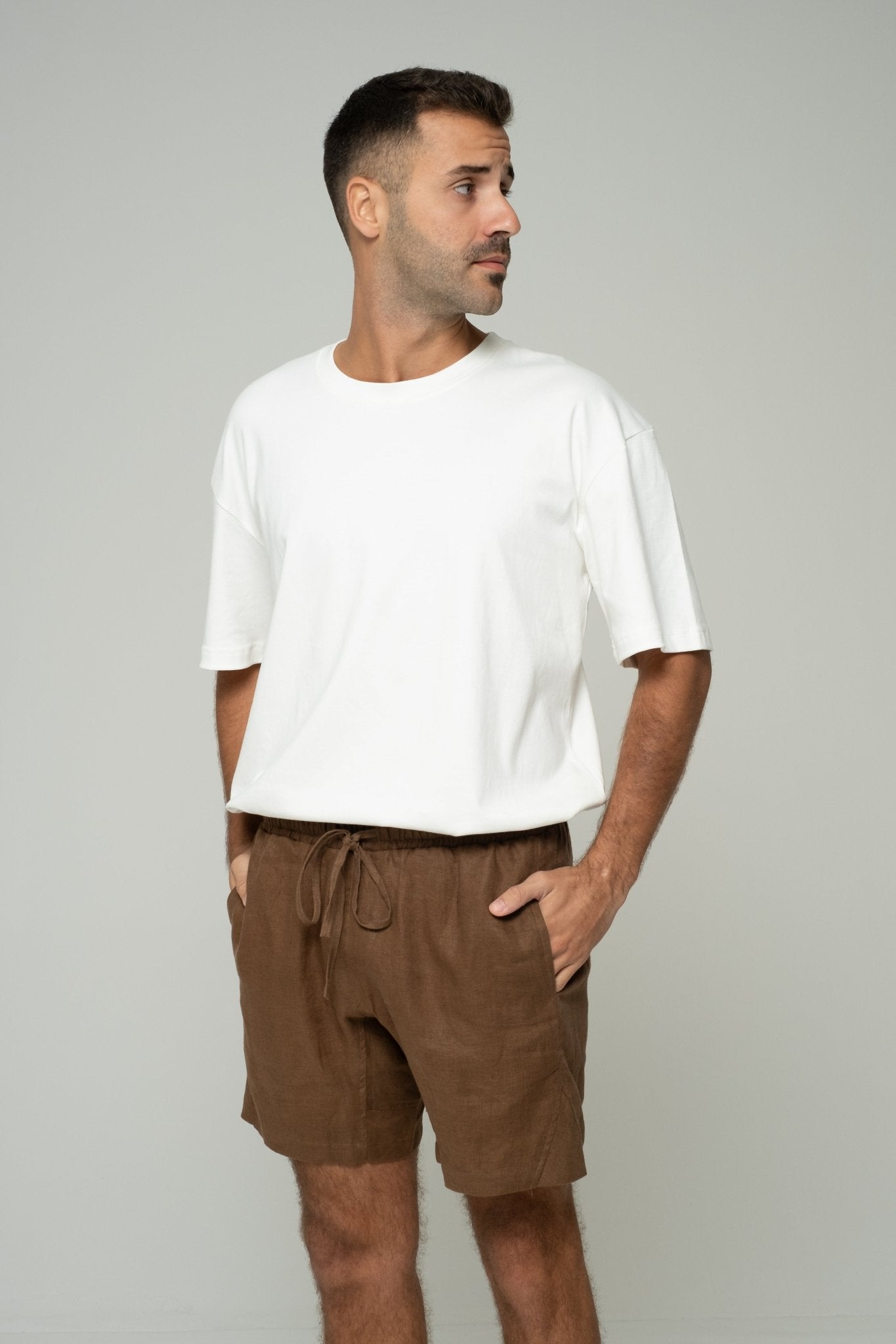 alt="Front view Coca tan shorts, relaxed cotton blend fit with dual side pockets."