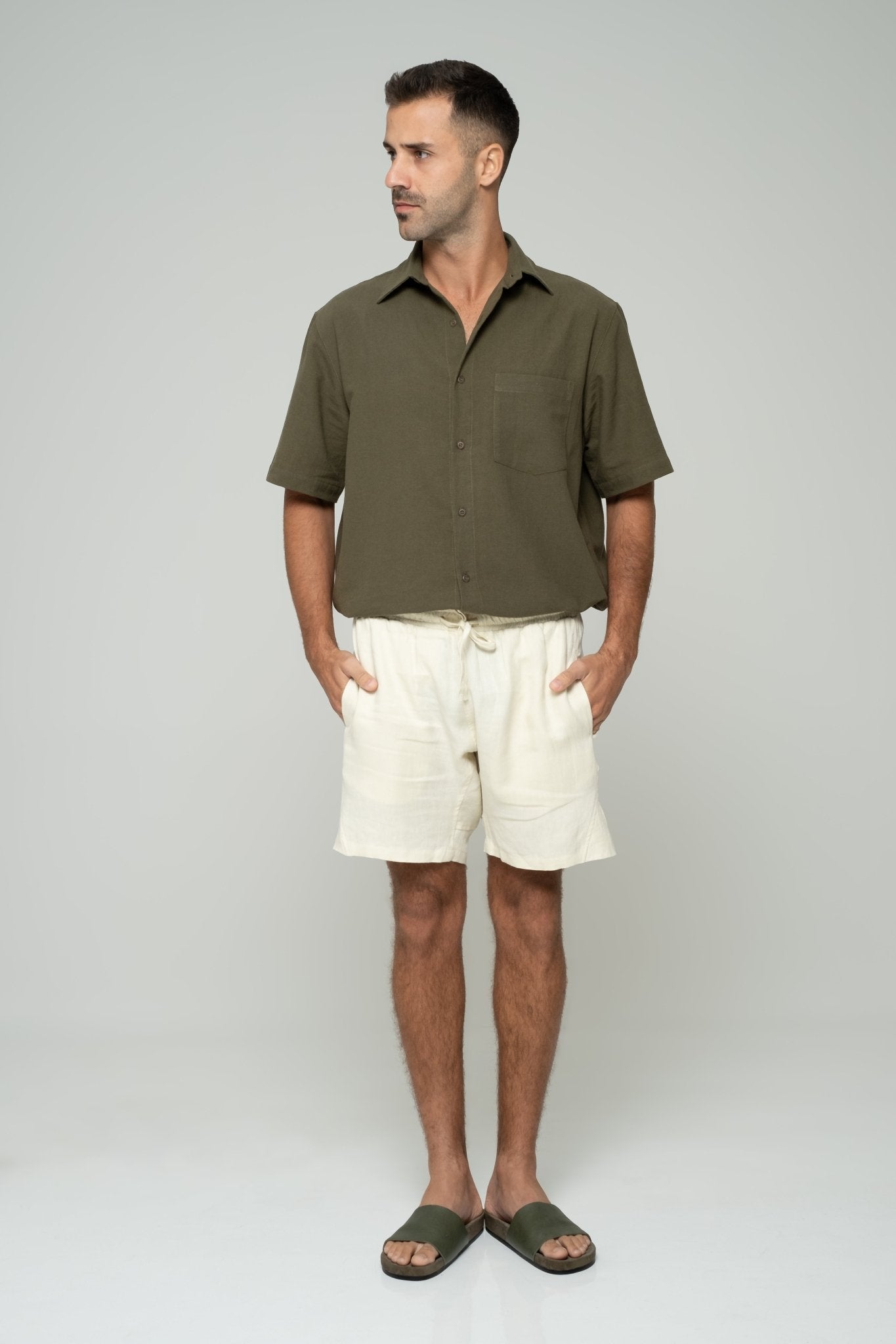 alt="Marrow shorts in off-white cotton blend, mid-length with drawstring waistband, side view."
