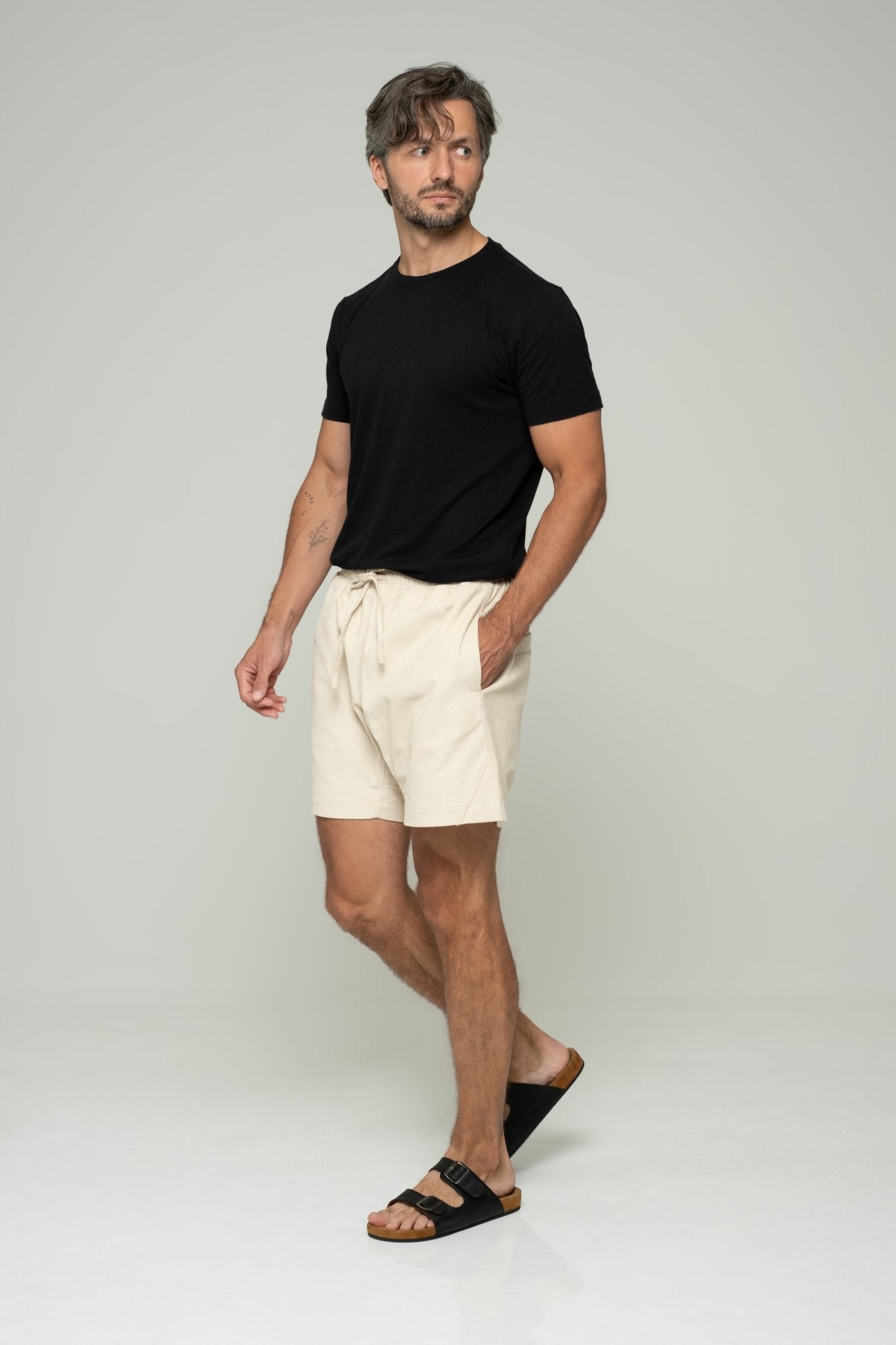 alt="Front view navy Monaco shorts, relaxed fit on model."